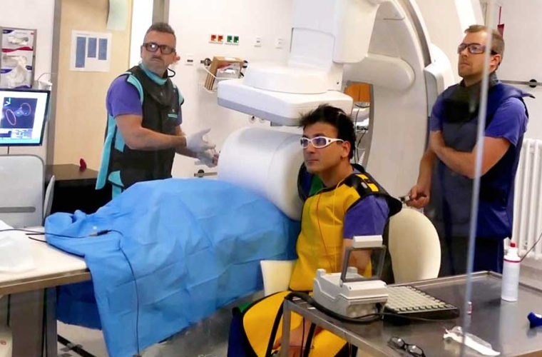 Erste MPI-Untersuchung am Menschen: Patrick Vogel (Proband, Mitte) hält seinen Arm in den MPI-Scanner, gemeinsam mit Viktor Hartung (Interventionalist, links) und Philipp Gruschwitz (Sicherheitsbeauftragter) verfolgt er das Live-Monitoring.