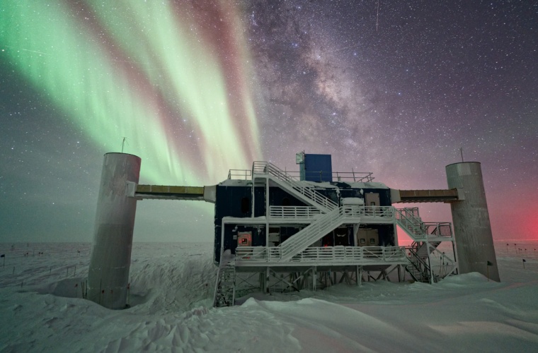 Auroras and the Milky Way light up the IceCube Laboratory from behind. PHOTO: ILYA BODO / ICECUBE/NSF
