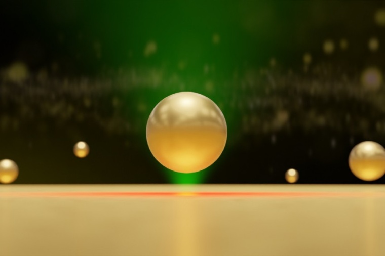 Abb.: Illustration eines Goldnanopartikels, der durch hydro­dynamische und...