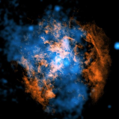 he white dot in the center of the image shows Sgr A*. In orange is data from the Atacama Large Millimeter/Submillimeter Array radio telescopes in Chile, mapping the location of cold gas composed of carbon monoxide in the image. In blue is X-ray data from NASA’s Chandra X-ray Observatory